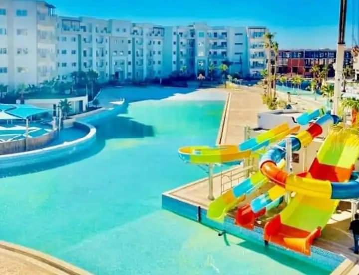 a swimming pool with a water park with slides at Palm Lake Ressort Monastir S2 in Monastir