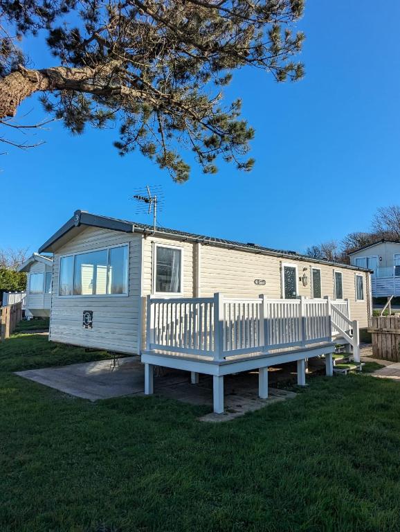 Casa móvil con porche y banco en Relaxing Holiday Home Chickerell View Littlesea Haven, en Weymouth