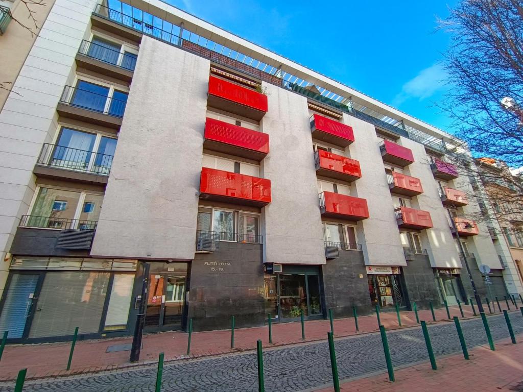 a building with red and red balconies on it at F151 Elitehost Futó Apartment in Budapest