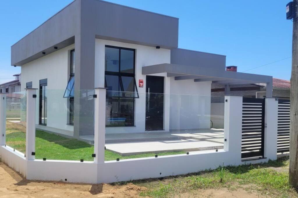 a rendering of a white house at Casa Mar Dom Pedro in Arroio do Sal