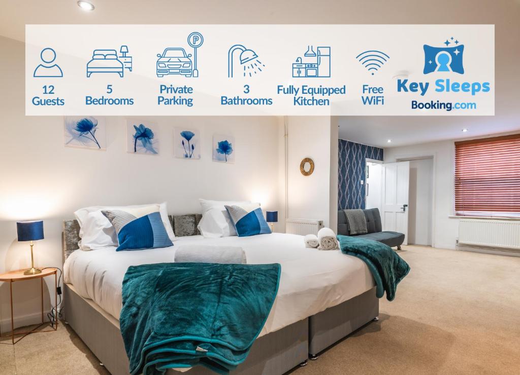 a bedroom with a large bed with blue and white sheets at LARGE Town Centre Townhouse for Work and Leisure inc Private Parking in Northampton