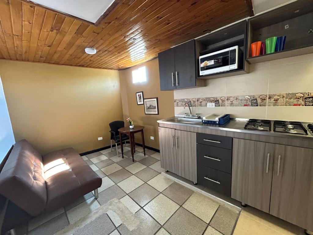 a kitchen with a couch and a table in a room at Villa Antonio in Zipaquirá