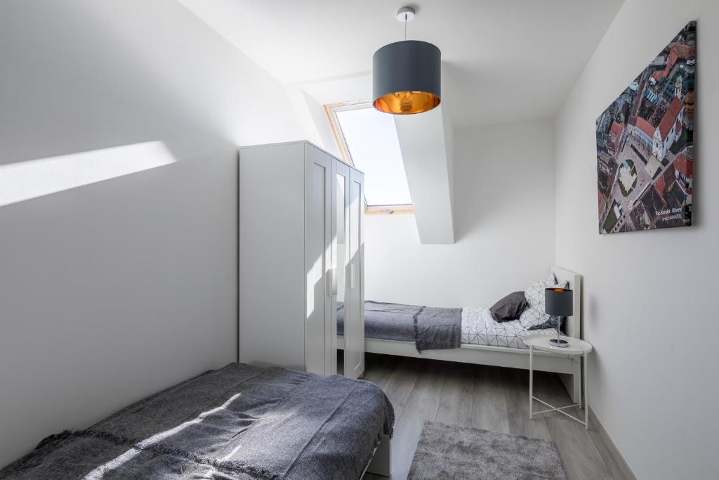 Postel nebo postele na pokoji v ubytování Stafétaház Apartmanok