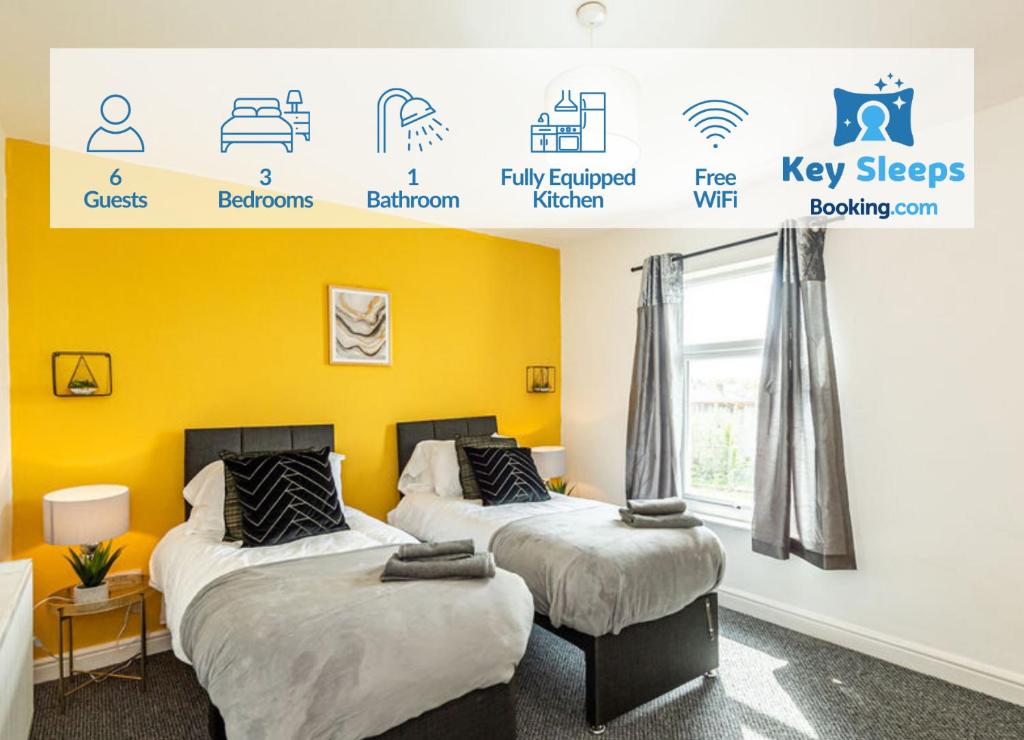 two beds in a room with yellow walls at Contractors & Leisure & Airport Location & Riverfront in Liverpool