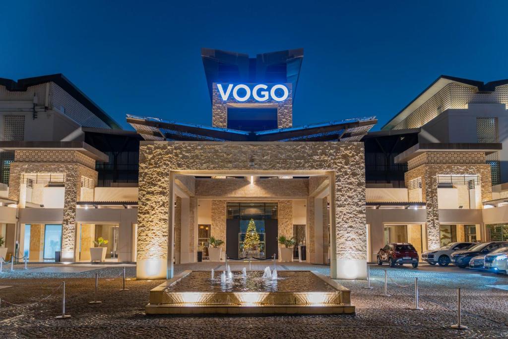 a vico building with a fountain in front of it at VOGO Abu Dhabi Golf Resort & Spa Formerly The Westin Abu Dhabi Golf Resort & Spa in Abu Dhabi