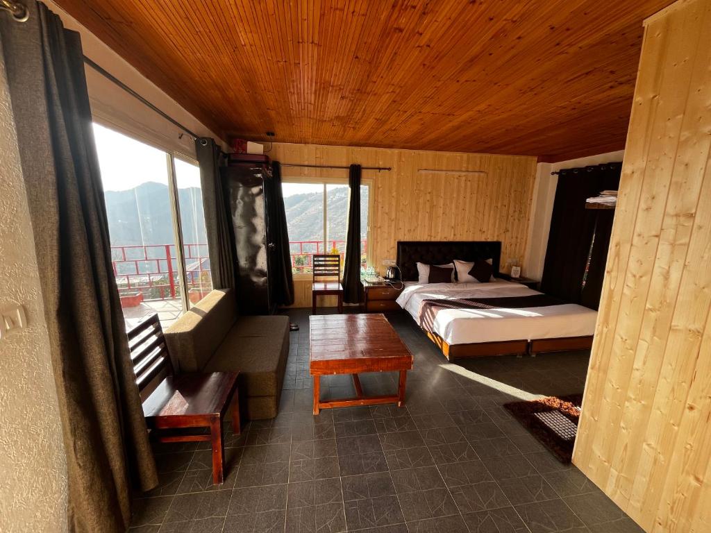 1 dormitorio con cama, sofá y mesa en Nature Nest Resort, en Mai Jūbar