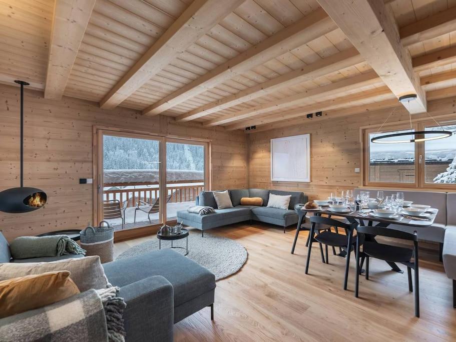 a living room with a table and a dining room at 3 Fontaines - Apt C1 - BO Immobilier in Châtel