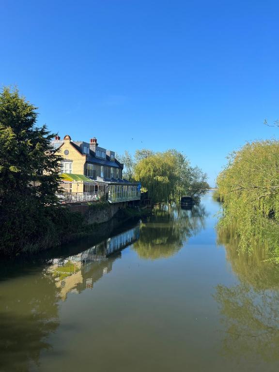 a river with a house on the side of it at The Three Pickerels in Mepal