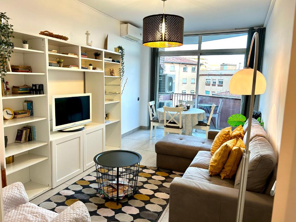 a living room with a couch and a tv at Apartment Sagrera in Barcelona