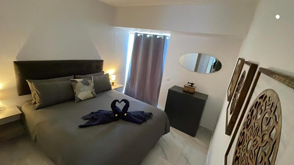 a bedroom with a bed with a ribbon on it at La Casita de Bonnie in La Tejita