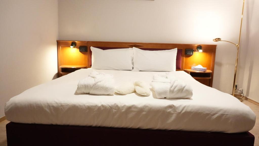 Postelja oz. postelje v sobi nastanitve SN Hotel and Restaurant