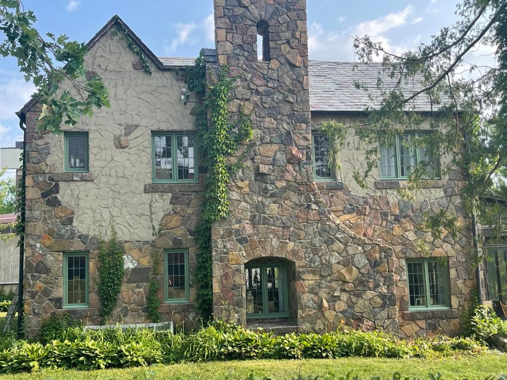 an old stone house with a tower at The Brower House in Saint Cloud