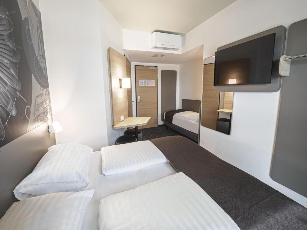 Postel nebo postele na pokoji v ubytování B&B HOTEL Wiener Neudorf
