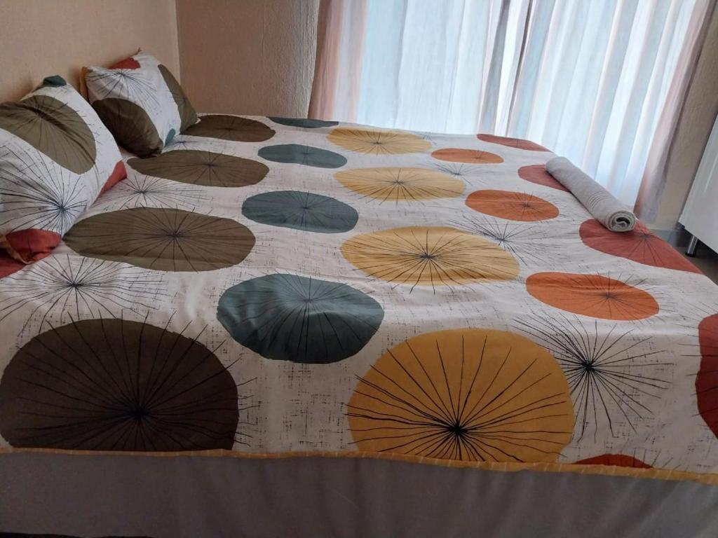 a bed with a bunch of umbrellas on it at The Grace quest house in Ngodini