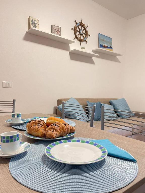 - une table avec des assiettes et des pâtisseries dans l'établissement CASA GIULIA - Holiday Home, à Olbia