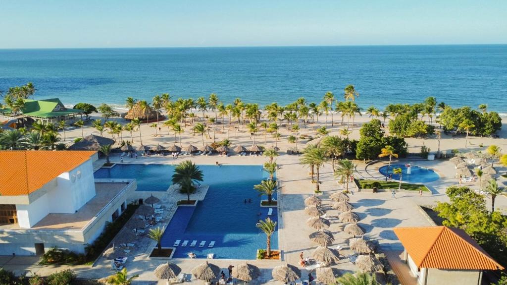 an aerial view of a resort with a pool and the ocean at Sunsol Ecoland in Pedro Gonzalez