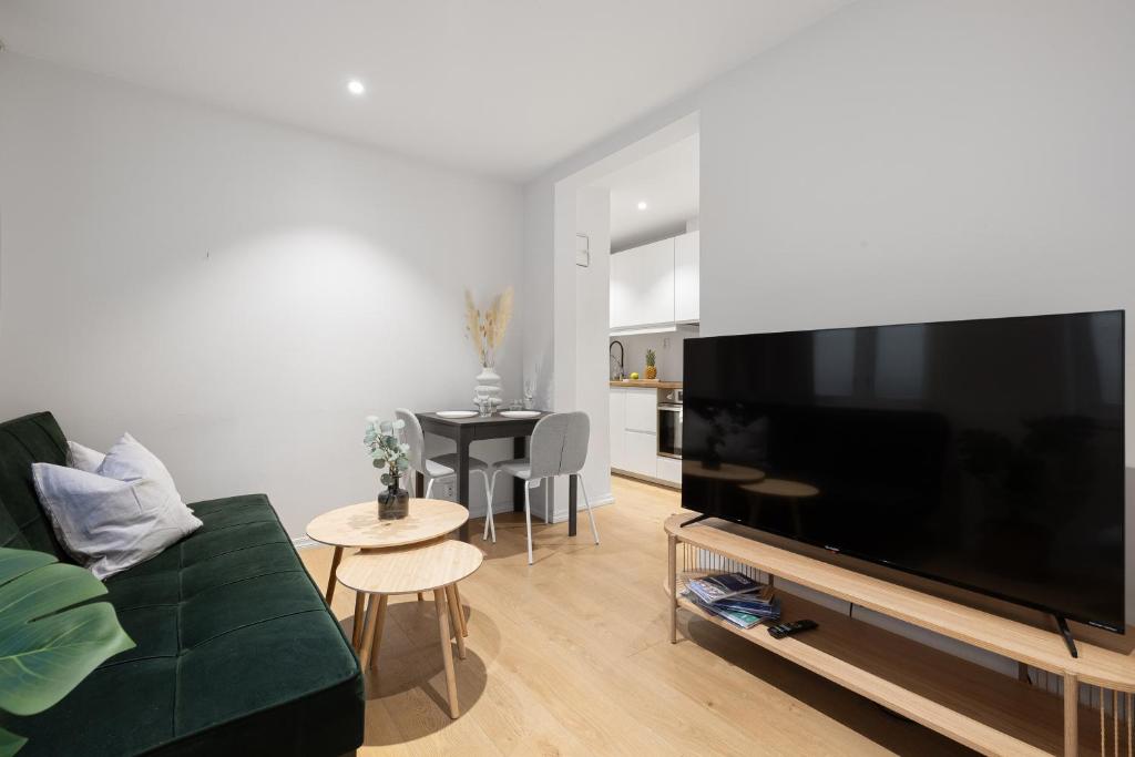 a living room with a large flat screen tv at 5min to Bryggen - Renovated - Budget friendly in Bergen