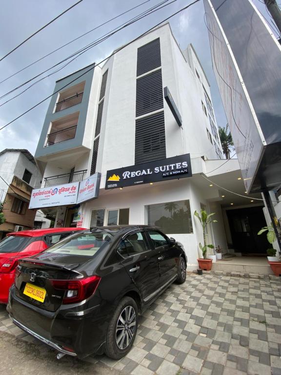 a black car parked in front of a building at REGAL SUITES in Trivandrum