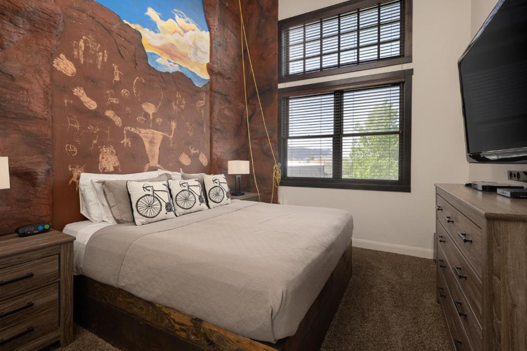 a bedroom with a large bed and a tv at Unique Downtown Rental - La Dolce Vita Villas #5 in Moab