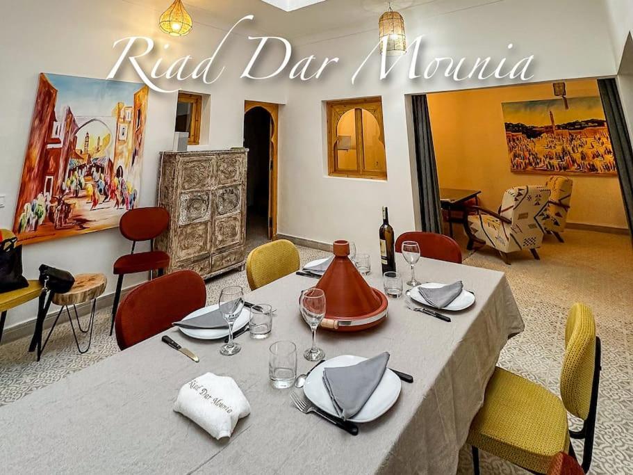 a dining room with a table and chairs and a sign at Riad Chic en Médina, Spa & Charme Marocain in Marrakesh