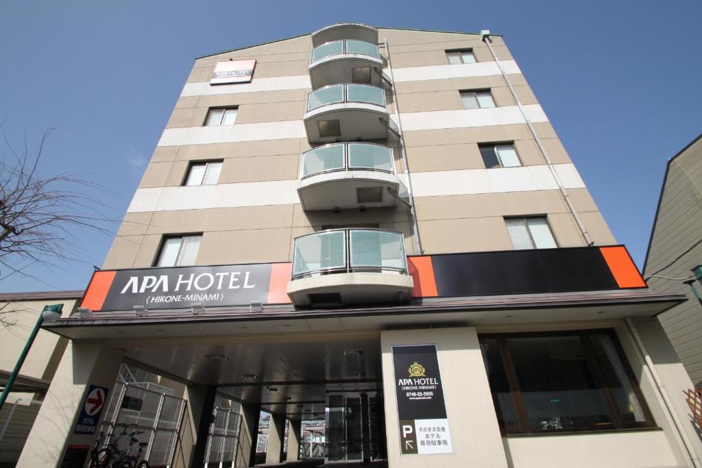 a building with a balcony on top of it at APA Hotel Hikoneminami in Hikone