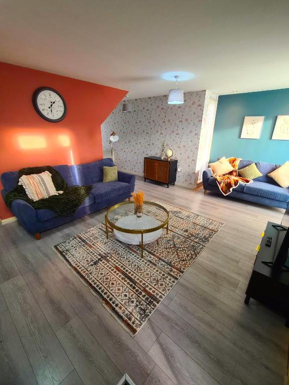 a living room with a couch and a table at 3 Bed House Etihad in Manchester