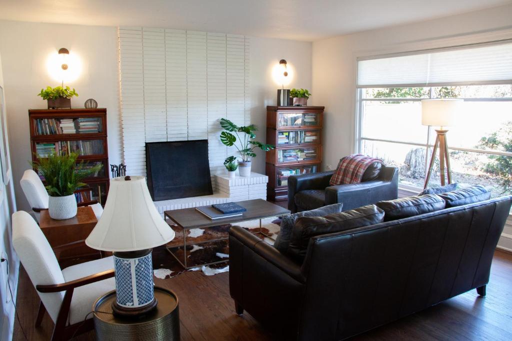 a living room with a couch and a table at Beautiful Ranch Style Home - Minutes from Downtown CVille! in Charlottesville
