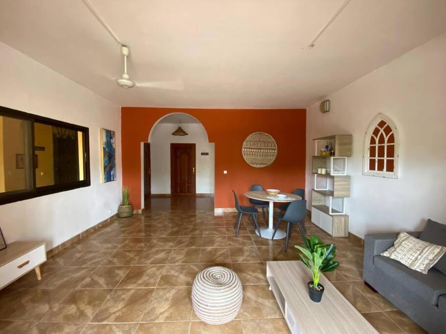 a living room with a couch and a table at Tropical House in Pamandzi
