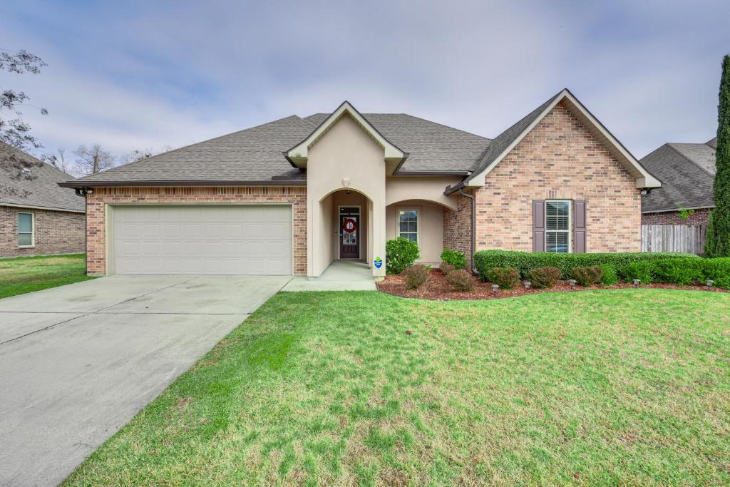 a house with a driveway and a garage at Spacious Zachary Home 12 Mi to Baton Rouge! in Zachary