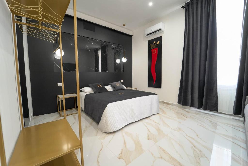 ein Schlafzimmer mit einem Bett und einer schwarzen Wand in der Unterkunft Élite Rooms in Neapel