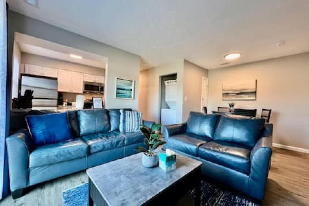sala de estar con sofás de cuero azul y mesa en Newly Remodeled Apt Middletown, Ohio FREE Laundry, en Middletown