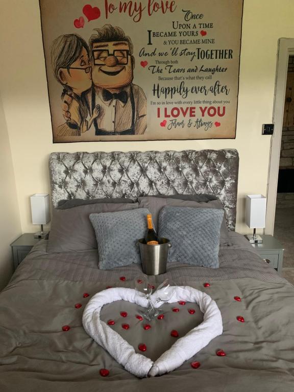 a heart shaped bed with a poster on the wall at Hays cottage in Halifax