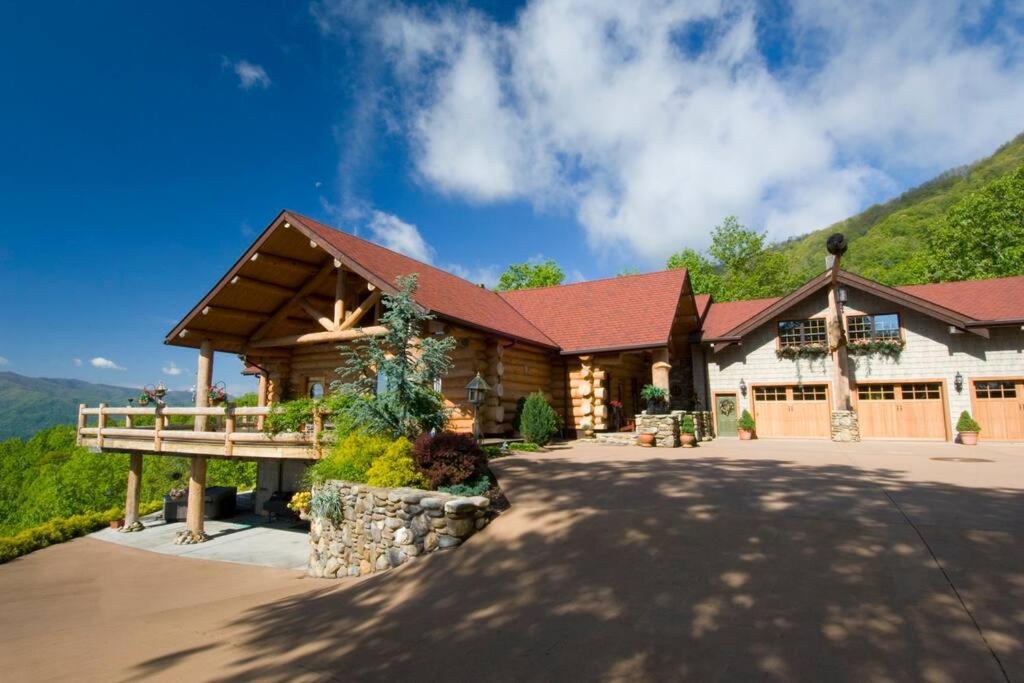 a log cabin with a deck and a mountain at LUXURIOUS TN Mtn Lodge- Sleeps 22+, Hiking & Lake in Butler