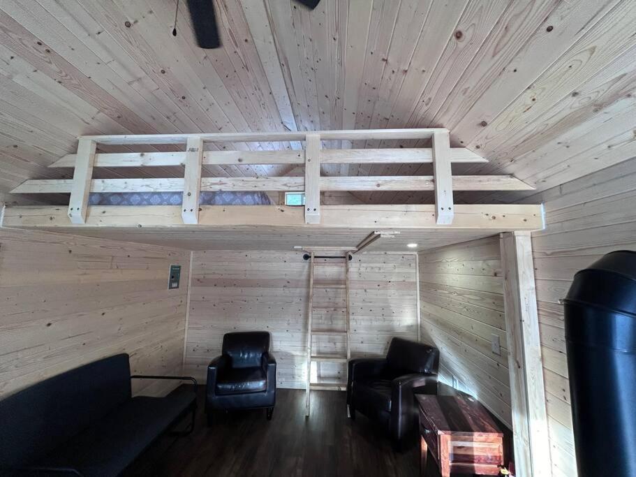 a room with two chairs and a bunk bed in a cabin at Eagle Cabin in Golden