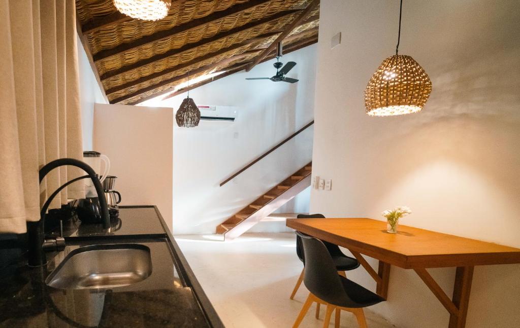 a kitchen with a wooden table and a sink at ALTO MAR by Alto Atins in Atins