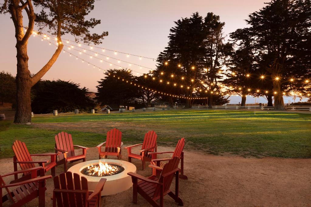 a group of chairs around a fire pit in a park at Oceanpoint Ranch in Cambria