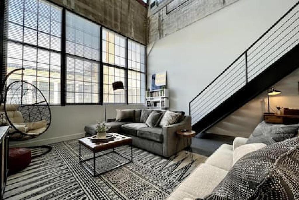 a living room with a couch and a table at 5104 Cartridge Factory Loft in Maineville