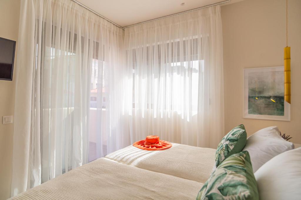 a bedroom with a bed and a large window at Samos Tropic Apartments in Ríva
