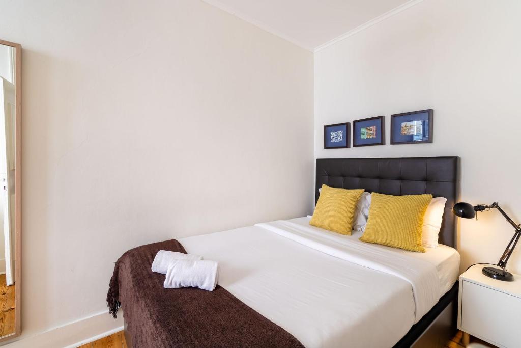 Postel nebo postele na pokoji v ubytování Diario de Noticias by Central Hill Apartments