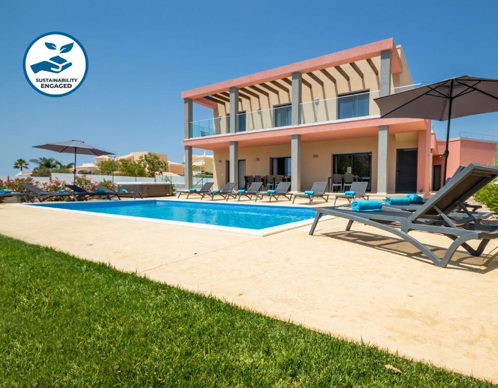 a villa with a swimming pool and a house at Villa Riviera by Algarve Vacation in Armação de Pêra