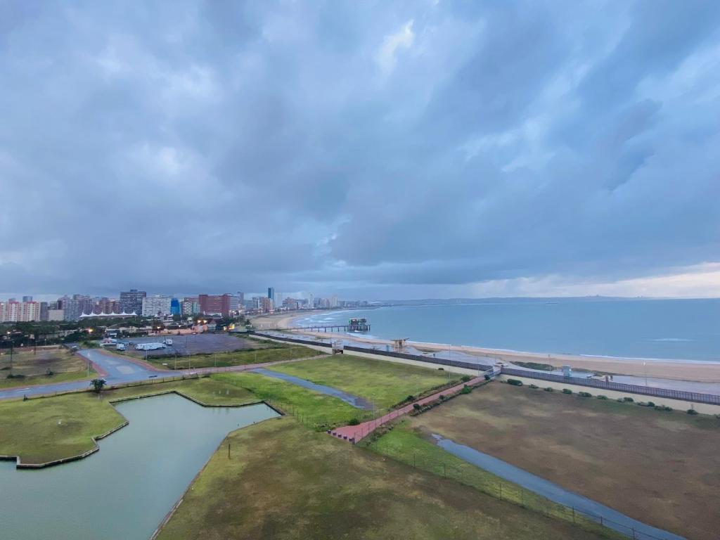 an aerial view of the beach and the ocean at The Waves 905 Quayside Point in Durban