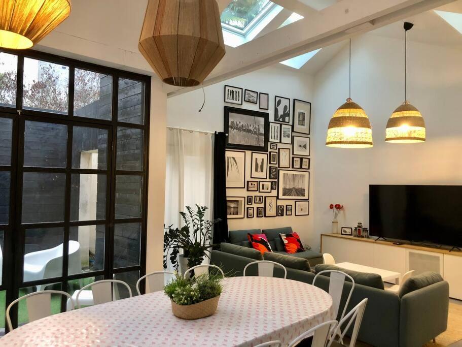 a living room with a couch and a table at La maison de Félix. Maison de bord de Loire. in Chalonnes-sur-Loire