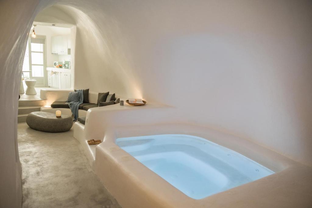 a large bath tub in a living room at Yposkafon Concept Villa in Megalochori