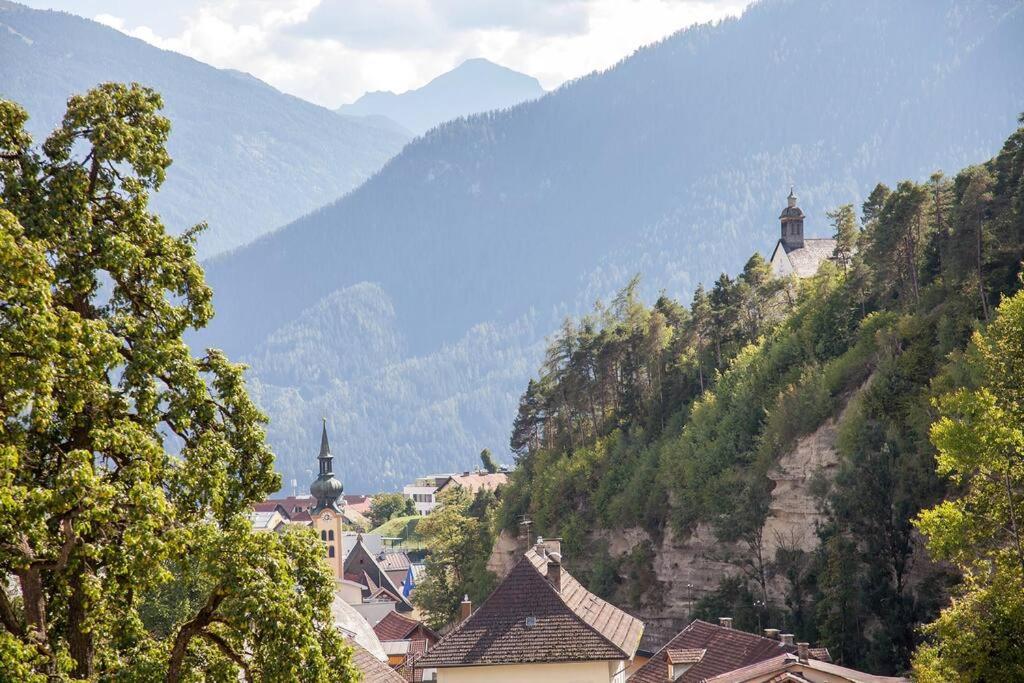 a town on a hill with mountains in the background at Cooldog Mini in Imst