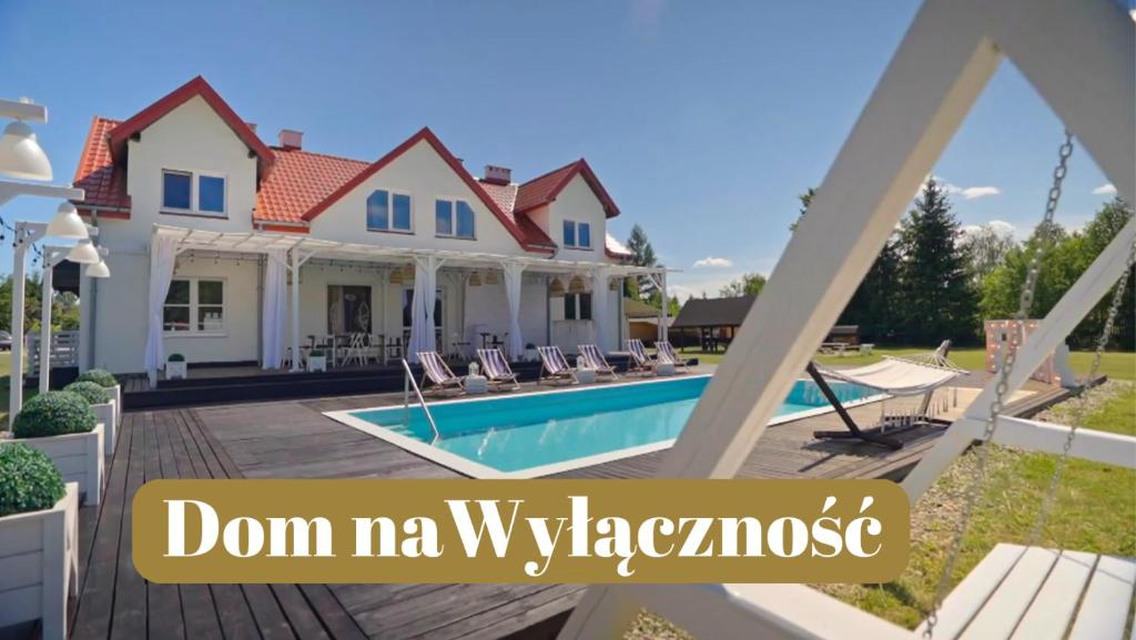 a house with a swimming pool in front of it at FARIE in Faryny