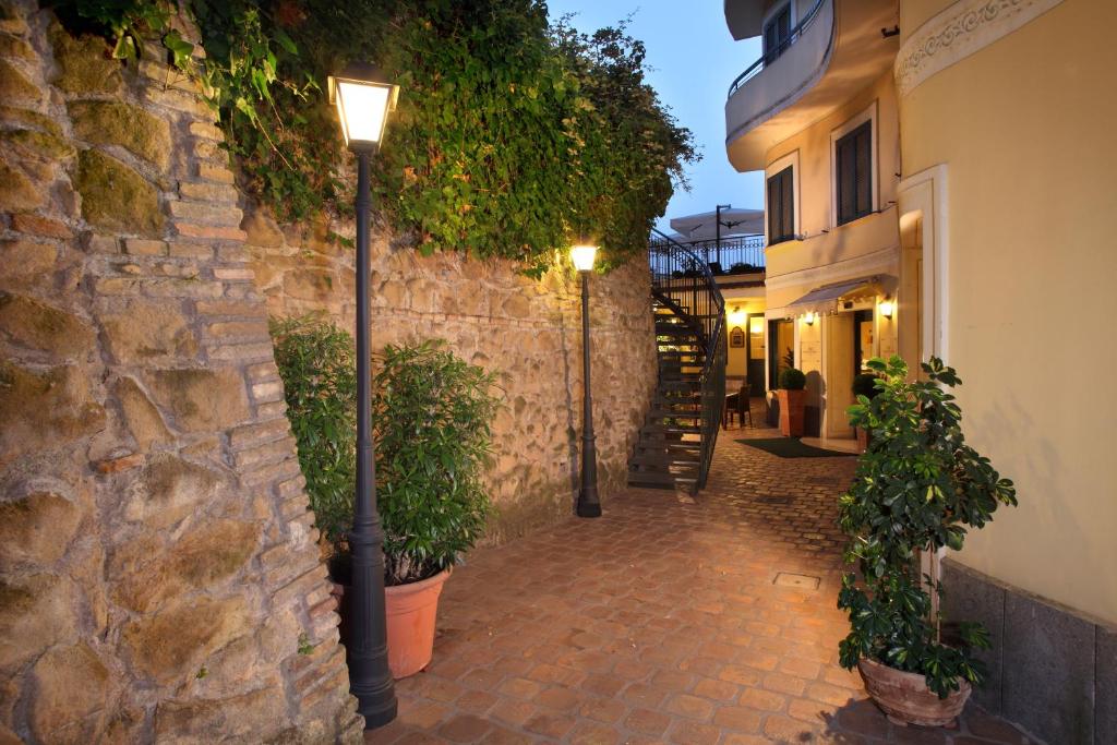 ein Straßenlicht neben einer Steinmauer in der Unterkunft Hotel Alessandrino in Rom