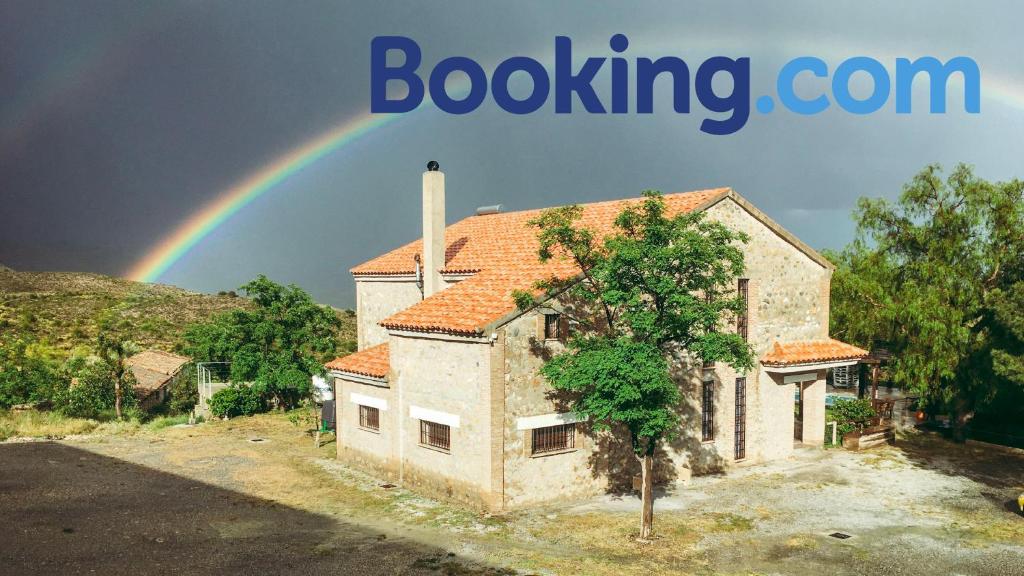 a rainbow in the sky over a house at Caserío Lo Bulle in Oria