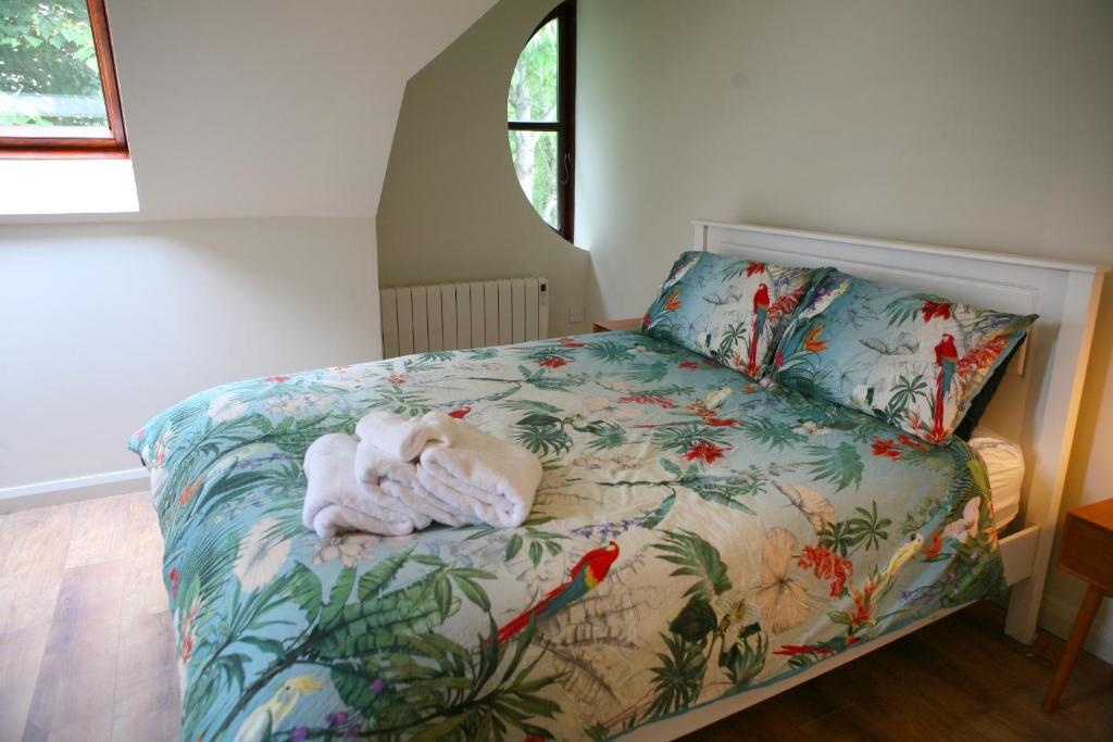 a bedroom with a bed with a towel on it at Blainroe Cottage 