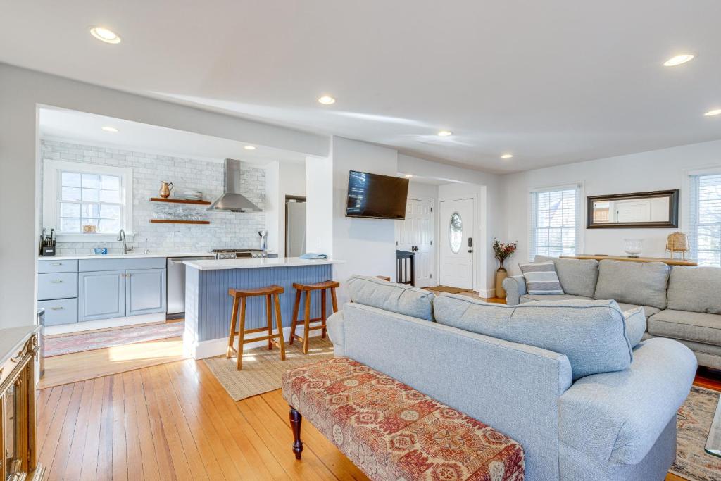 a living room with a couch and a kitchen at Greenport Home with Harbor View Near Ferry and Beaches in Greenport