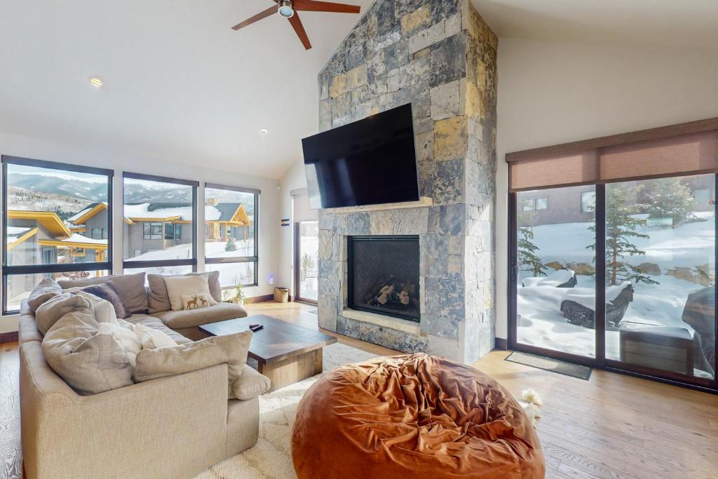a living room with a couch and a fireplace at A Slice of Silverthorne in Silverthorne